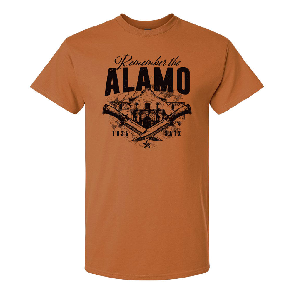 Remember the Alamo T-Shirt in Texas Orange, featuring a black graphic of the Alamo, two crossed knives, and the text Remember the ALAMO 1836 SATX.