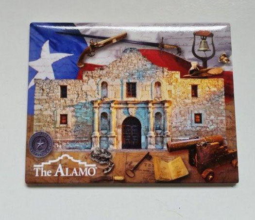 The Alamo Collage Magnet features the Alamo before a Texas flag, surrounded by vintage items like a pistol, rifle, lantern, cannon, coin, map, and book. "The Alamo" is displayed in the lower left corner of this decorative magnet.