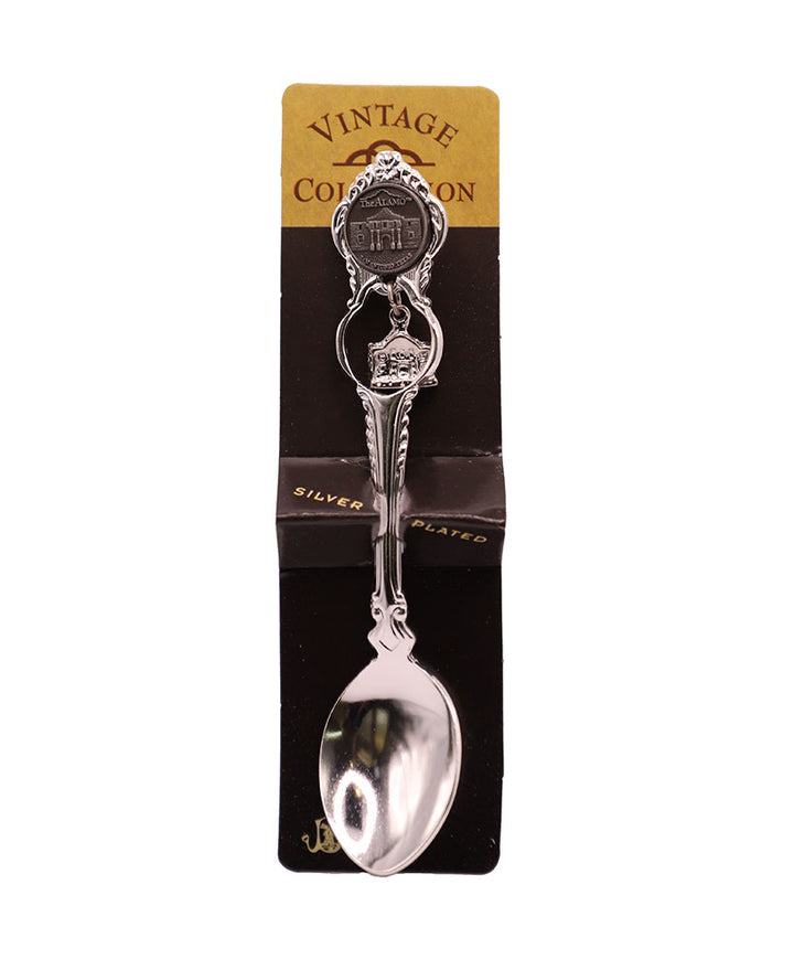 The Alamo Charm Spoon features ornate silver plating and an Alamo charm on the handle, displayed on a black and gold “Vintage Collection” card—perfect as a Texas independence gift.