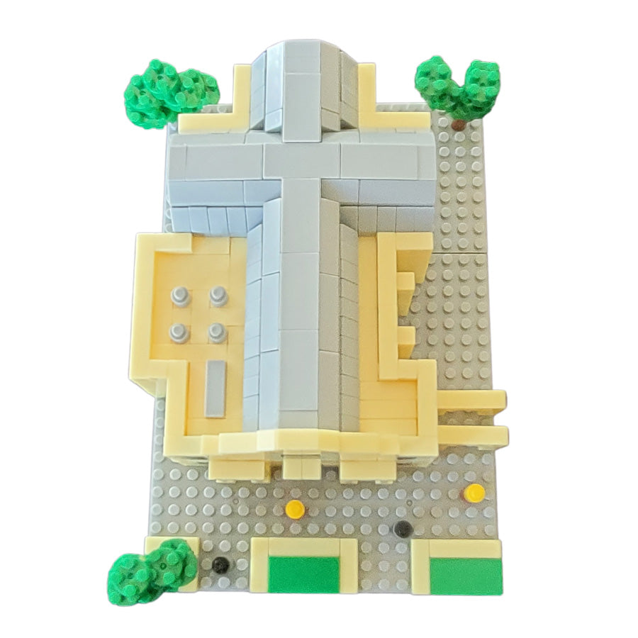 The Mini Alamo Building Block Set features a cross-shaped roof, gray tiles, green trees, and small yellow-green details—seen from above. Perfect for mini block fans, it includes detailed assembly instructions.