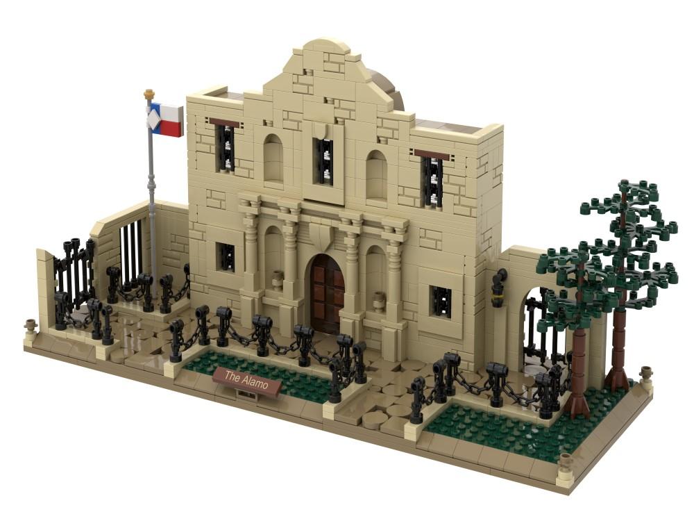 The Alamo Atom Brick is a detailed 1:100 scale model featuring tan bricks, arched doorway, windows, trees, black fences, a "The Alamo" plaque, and a Texas flag on the left—ideal for history and construction enthusiasts.