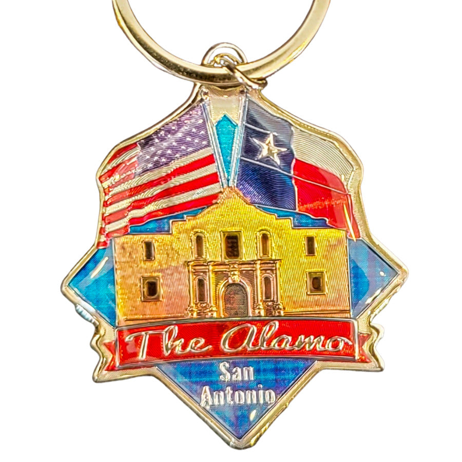 The Diamond Keychain is a holographic keychain featuring the Alamo building, "The Alamo" and "San Antonio" text, and U.S. and Texas flags in the background.