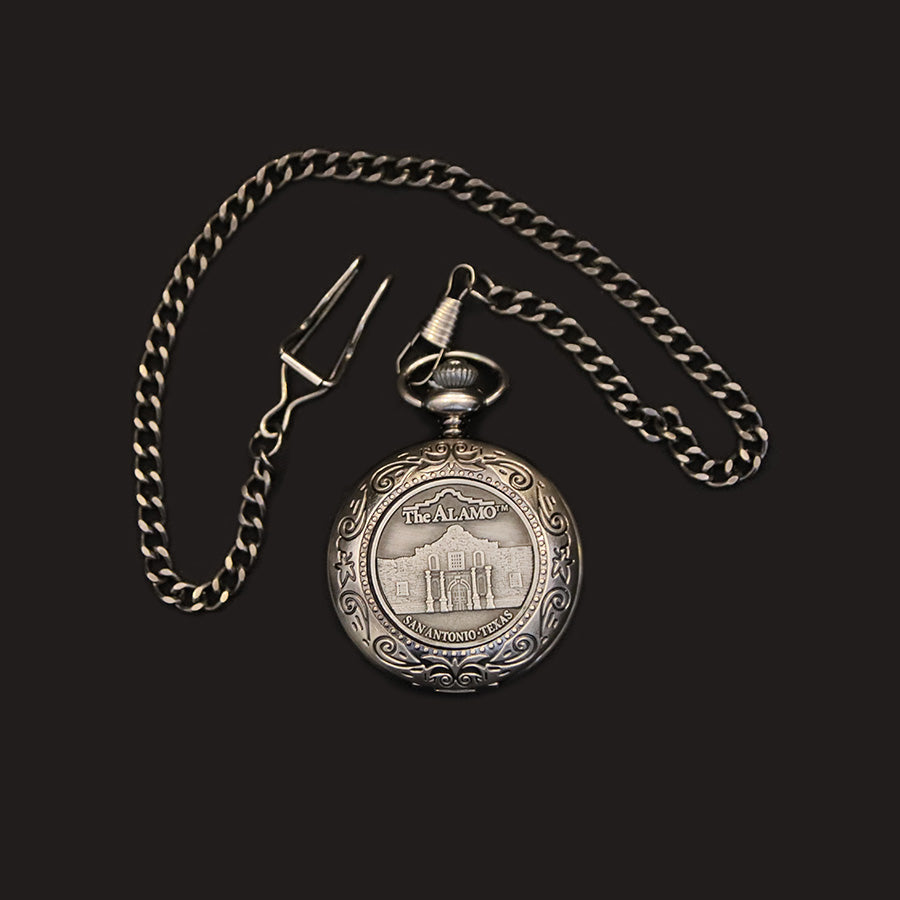 The Pocket Watch features a silver case with an engraved Alamo image and the words "The Alamo, San Antonio, Texas" on the front. It runs on precise quartz movement with a button battery and includes a matching chain, all set against a black background.