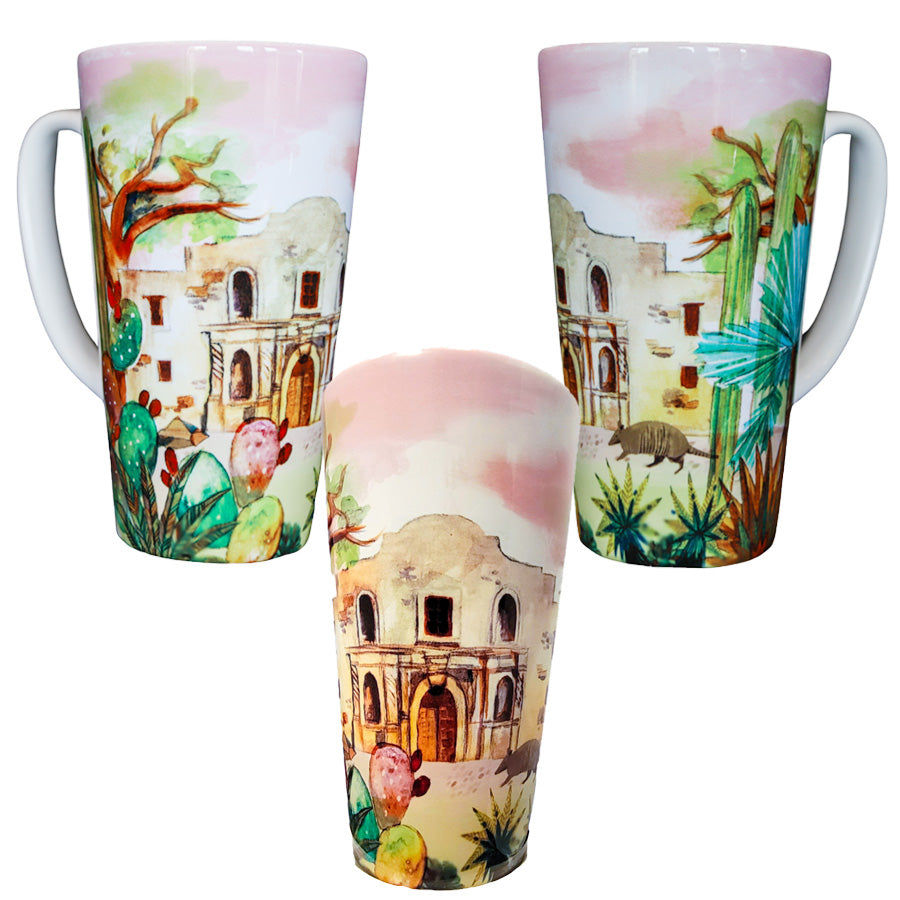 The Watercolor Mug features tall ceramic construction with watercolor-style illustrations of the Alamo, desert plants, and cacti. Each mug is shown from a unique angle to highlight its colorful, detailed design.